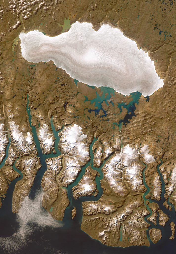 Jay Hart&nbsp;• <em>Barnes Icecap</em>&nbsp;• Inkjet print of Landsat imagery&nbsp;• 37″×&nbsp;54″&nbsp;• $800.00<div class="fb-text&quot><p style="margin-top:5px; text-align:center; font-size: 0.8em; ">In the middle of Baffin Island is this 20000 year old remnant of our last North American continental ice sheet. It is more melted than nearby icecaps, perhaps telling that its position used to be more of a cold locus than it is under today's climate. The fine exposure of ice layers and corduroy gullying on its steepest slopes are more pronounced here than anywhere else, at least over so large a feature. There are collapsing smears along its upper (south) margins - showing mud overflow and an oscillating fringe of meltwater deposits. Unlike the smaller iced ranges near the coast at the bottom (with their puddled terminal ponds), the Barnes Icecap remains intact but shrinking, like a hardened place in decline. </p></div>