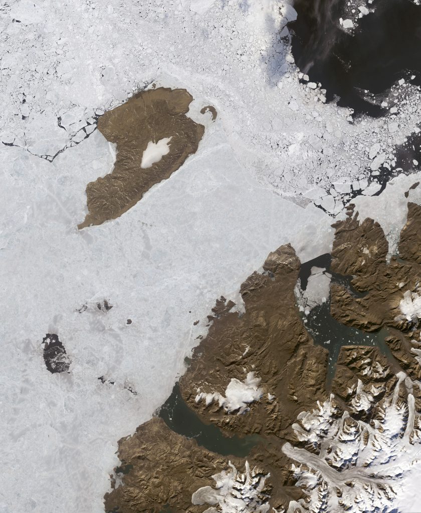 Jay Hart&nbsp;• <em>Meighen and Axel Heiberg</em>&nbsp;• Inkjet print of Landsat imagery&nbsp;• 17″×&nbsp;20″&nbsp;• $200.00<div class="fb-text&quot><p style="margin-top:5px; text-align:center; font-size: 0.8em; ">The little island, Meighen, has a small icecap which is naked of snow cover, like the Barnes. Its big neighbor at lower right, Axel Heiberg, is shedding ice without pushing it into the sea. In many spots ice is thinning and likely sublimating on the coastal plain. This melt scene is happening despite the short summers of 80 degrees north (it is the south edge of the Arctic Riviera on the west shores of Axel Heiberg and Ellesmere Islands). In a different era this was a snow (and glacial) center as shown by the very thick troughs of the fjord areas. The whole of the Arctic Ocean circulation has recently been collecting sea ice in this area, more so than for any other set of Arctic shorelines. </p></div>