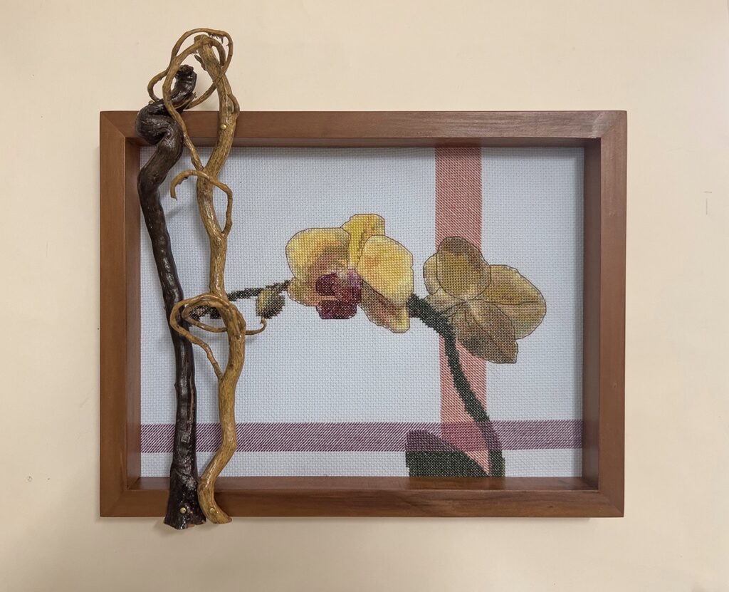 Eva M. Capobianco&nbsp;• <em>Orchids with Branch and Vine</em>&nbsp;• Cross stitch, found and reused wood&nbsp;• 13″×&nbsp;12″×&nbsp;3″&nbsp;• $175.00