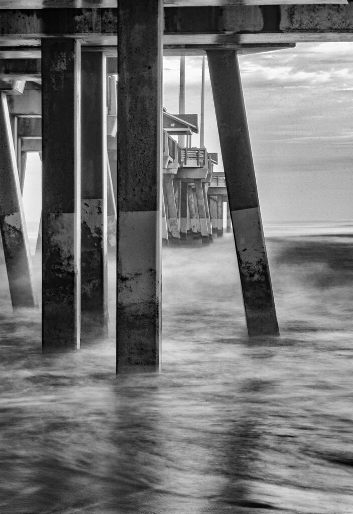 Debra Rockefeller&nbsp;• <em>From Under the Pier</em>&nbsp;• Digital photography BW matte finish metal frame black&nbsp;• 19″×&nbsp;25″&nbsp;• $500.00